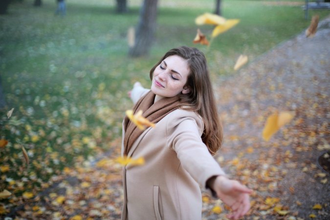 girl-dancing-in-fall-leaves